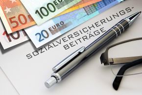 © Butch - stock.adobe.com Foto: Euroscheinen und Schriftzug Sozialversicherung